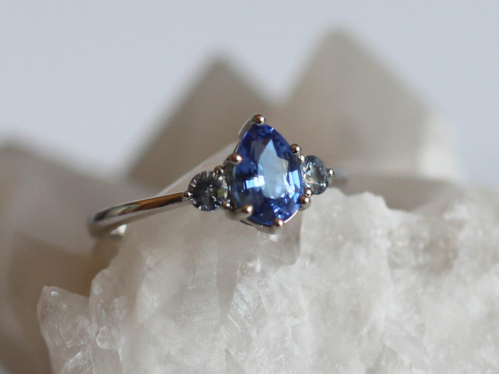Clarisse Ocean blue sapphire trilogy ring styled studio view