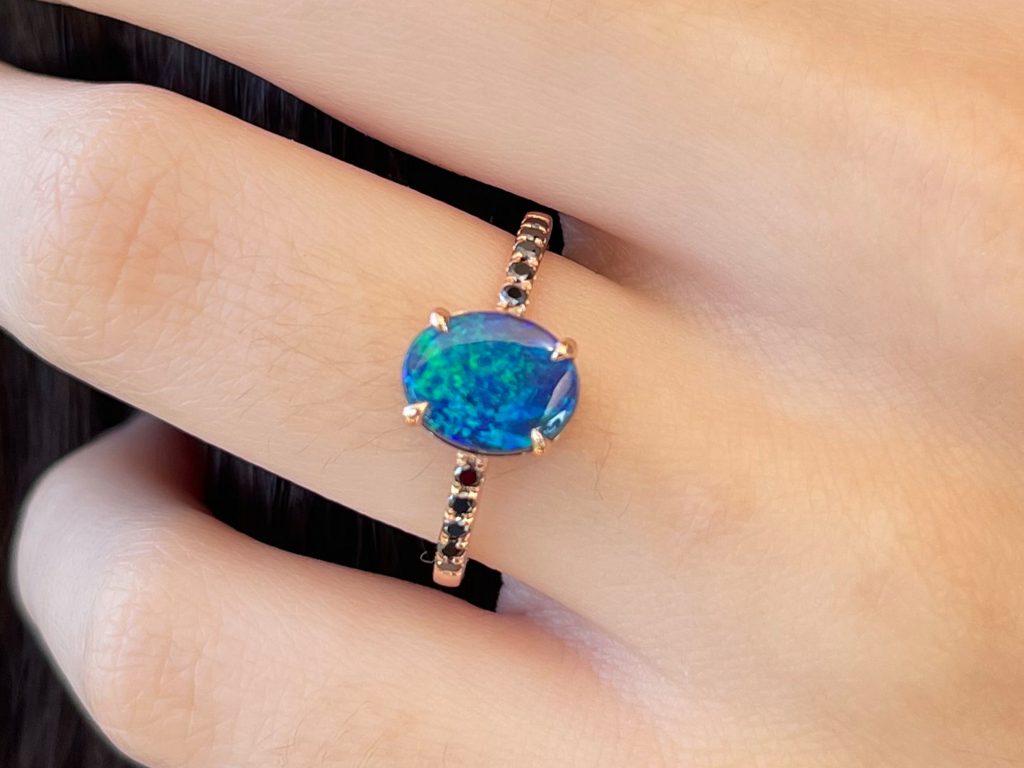 Ottavia Lightning Ridge black opal and diamond ring worn on hand for scale