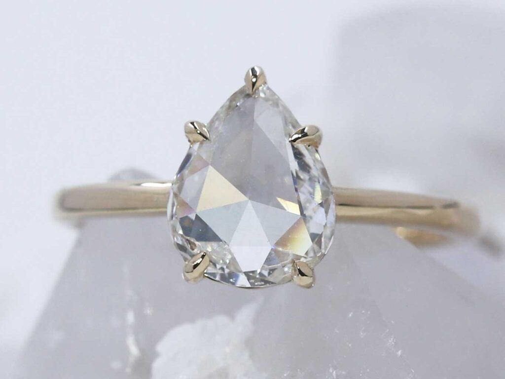 Sara pear rose-cut white diamond engagement ring styled studio view