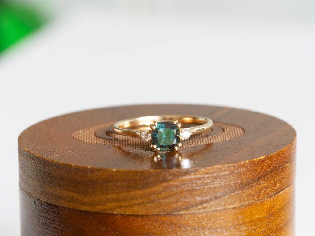 Serena Petite teal parti sapphire and diamond ring styled studio view